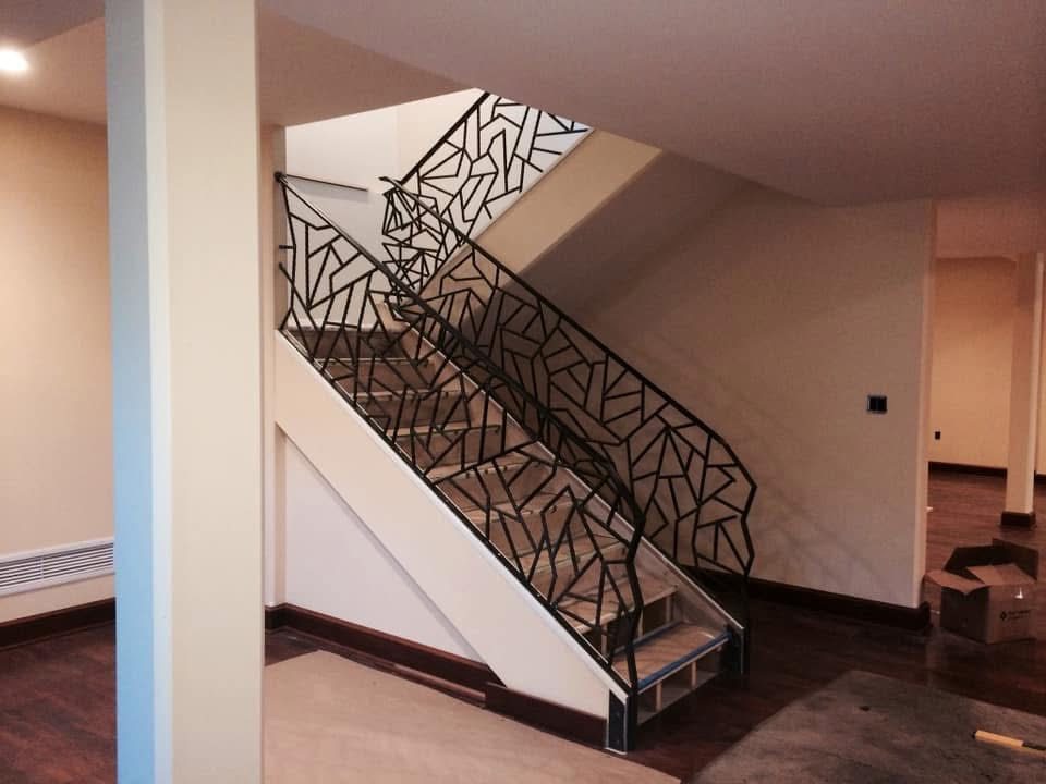 Custom laser-cut metal handrail and cable railing system installed on residential property in North Idaho