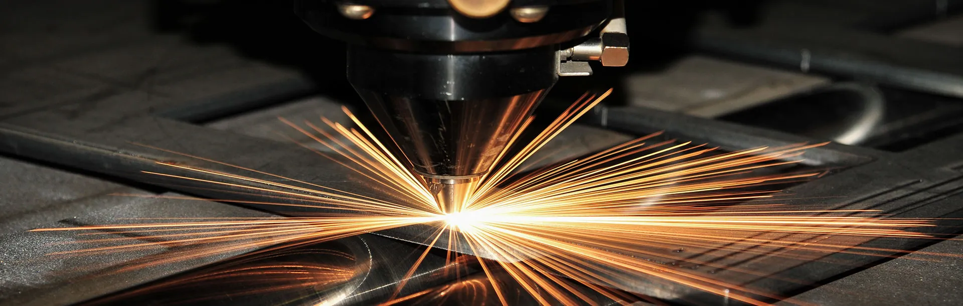 CNC fiber laser cutting steel plate with precision sparks at The High Road Manufacturing — 6kW fiber laser for steel, aluminum, and stainless steel cutting